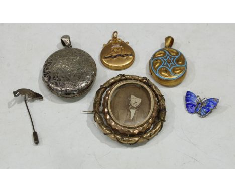 A silver pendant locket; a pinchbeck mourning brooch; a pinchbeck locket; a silver and enamel butterfly brooch; a silver badg