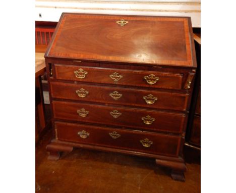 A George III mahogany bureau, with crossbanding, the stepped interior fitted with pigeon holes and small drawers, with four l