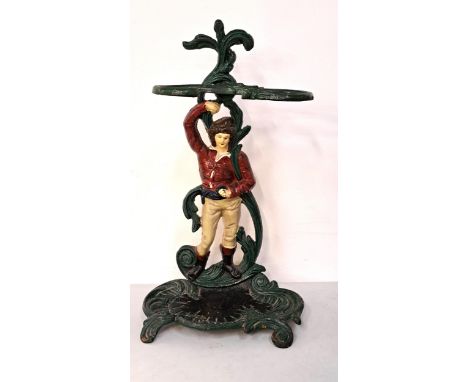 CAST IRON ANTIQUE UMBRELLA STAND depicting a man in boots with sash, 56cm high 