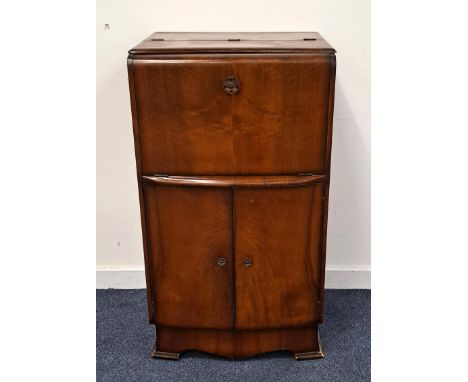 RETRO MAHOGANY VENEERED DRINKS CABINETthe fall flap triggering an internal mechanism to bring the mirrored shelf up and out, 
