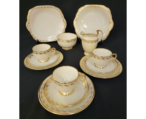 YE OLDE ENGLISH GROSVENOR CHINA TEA SET with gilt decoration on a cream ground, comprising eleven cups and saucers, twelve si