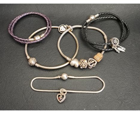 FIVE PANDORA BRACELETScomprising a Family Tree Heart clasp silver charm bracelet, a silver Moments Celebration bangle, an Ess