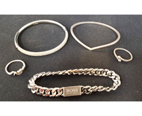 SELECTION OF FASHION JEWELLERY comprising a Pandora silver wishbone bangle, a Swarovski bangle, two Pandora rings and a Hugo 