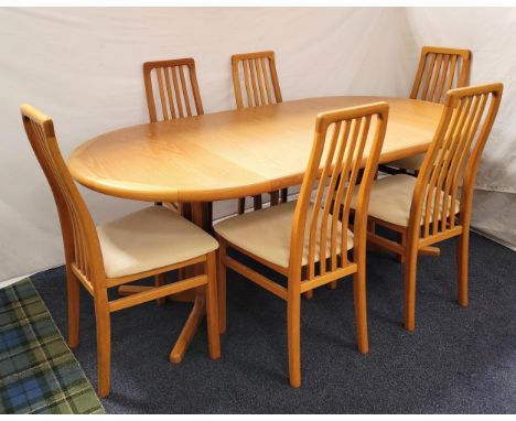 DANISH MID CENTURY OAK EXTENDING PEDESTAL DINING TABLE BY LAURITS M. LARSEN AND SIX CHAIRSthe table with two additional leave