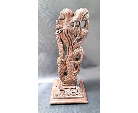 BURMESE CARVED HARDWOOD DRAGONraised on a square stepped base with a carved dragon, originally a table lamp, 46.5cm high 