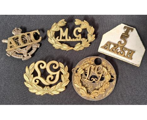 SELECTION OF SIX MILITARY BADGES comprising WWI Guards Machine Gun Regiment cap badge; WWI Machine Gunner arm badge; two WWI 