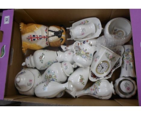A collection of pottery to include Aynsley wild tudor, clocks, lidded vases, bud vases, vases, ornamental wheelbarrow and lar