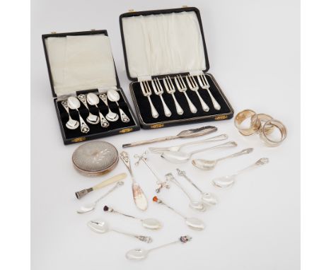 A mixed lot of silver items to include napkin rings, compact, spoons, fork etc, total weight 9.05oz, a boxed set of silver te