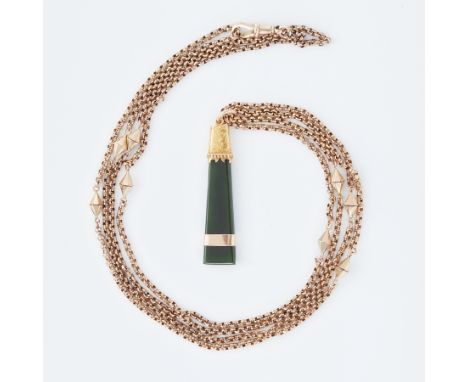 An antique 15ct yellow gold pendant set with an elongated triangular shaped dark green jade with a flower engraved gold band 