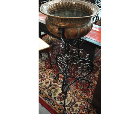 Arts & Crafts design copper and verdigris baluster planter standing on a wrought iron scroll decorated tripod base. (B.P. 21%
