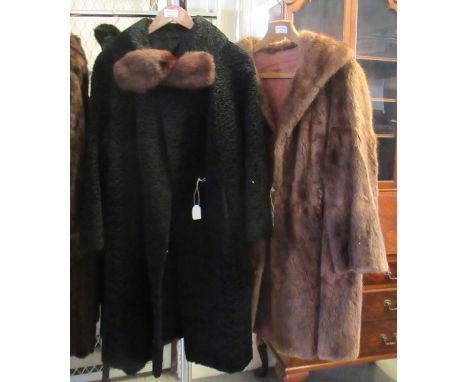 Two vintage fur coats: one brown and one black Astrakhan with 'Harella' and 'Astran, Paris' labels. (2)(B.P. 21% + VAT) 