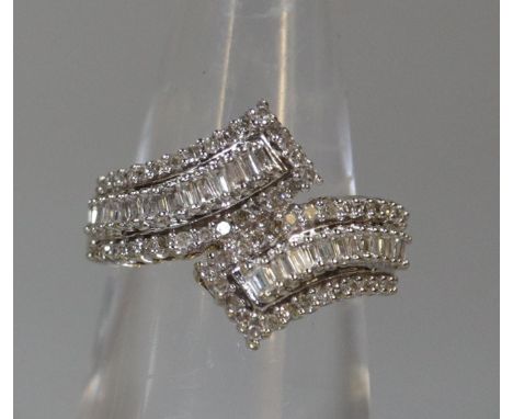 9ct gold and diamond dress ring in crossover setting.  Ring size K&1/2.  Approx weight 3.4 grams.(B.P. 21% + VAT) 