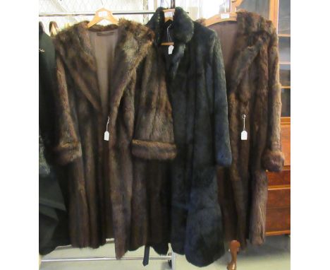 Three vintage fur coats: one black coney or rabbit fur with belt, two dark brown; one with CC41 utility label to the lining. 