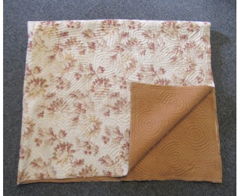 Vintage cotton reversible Welsh quilt with leaf pattern, one side plain light brown and the other floral and foliate print. (