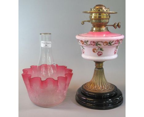 Early 20th Century double oil burner lamp having cranberry glass etched foliate shade, above an opaline pink and cream glass 