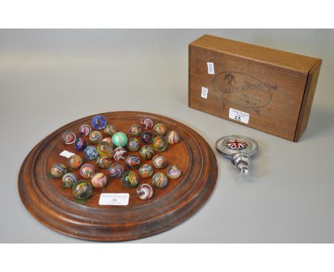Solitaire wooden and moulded games board comprising a collection of vintage hand made marbles, together with a wooden box mar