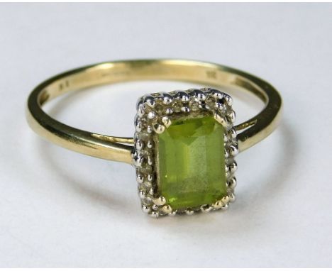 GOLD RING. A 9ct. gold peridot &amp; diamond dress ring, (R).