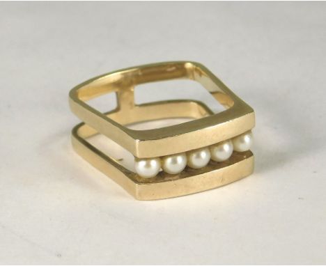 GOLD RING. A 9ct. gold, pearl set ring, the split shank of square shape, (J/K).