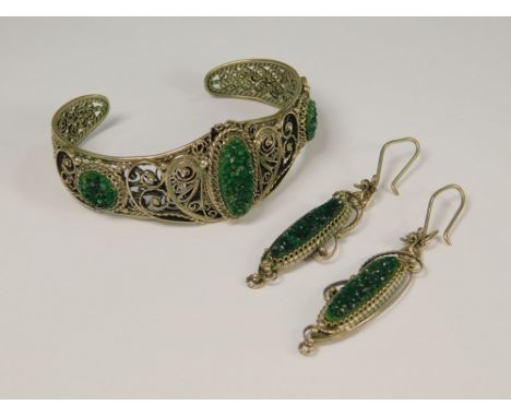 RUSSIAN JEWELLERY.A filigree bangle & matching earrings, each set with random green stones (purchased in Russia).