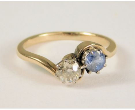 GOLD RING. An 18ct. gold sapphire &amp; diamond, cross-over ring, each stone of approximately 0.25ct. spread. (K)