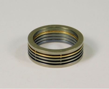 JOEL DEGEN. A Joel Degen stainless steel, titanium &amp; 18ct. gold ring. (Q). Provenance: Purchased from the Craft Centre &a