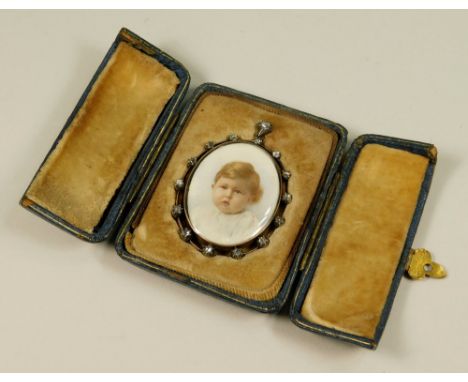 MINIATURE PORTRAIT. A miniature hand painted portrait on ivory of a young child. Framed in yellow metal, set with old cut dia