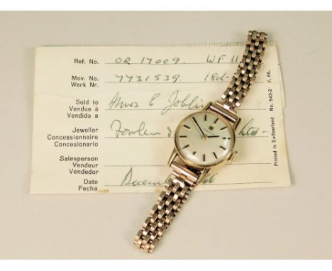 GOLD WATCH. A lady's 18ct. gold cased Tissot wrist watch on 9ct. gold bracelet strap. Sold with original guarantee dated Dece