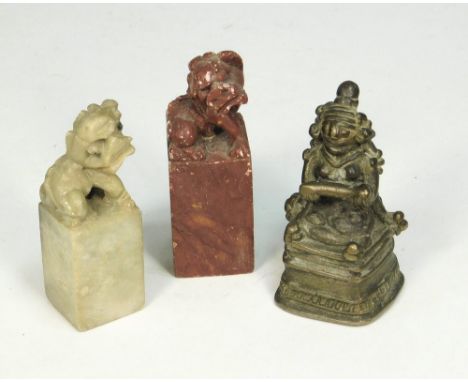 SEALS ETC. Two Chinese carved soapstone seals, largest 6.5cm &amp; a cast metal figure holding a scroll. (Possibly a seal box