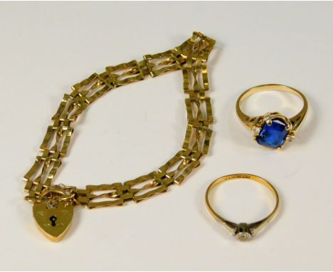 GOLD BRACELET ETC. A modern 9ct. gold gate bracelet, an 18ct. gold &amp; platinum solitaire diamond ring &amp; a 10K dress ri