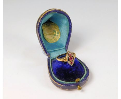 VICTORIAN RING. A Victorian unmarked gold ring, with a row of three collet set rubies, within a diamond set navette frame, (J