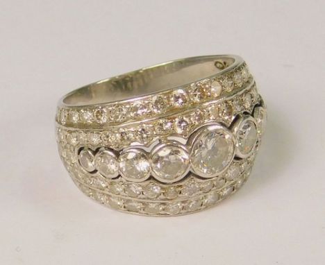 DIAMOND RING.An unstamped, white metal dress ring, set throughout with white sapphires & small brilliant cut diamonds, (K). A
