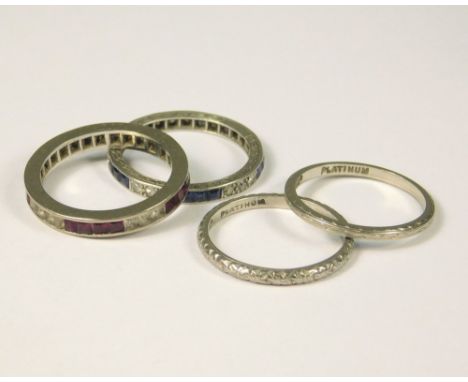 PLATINUM RINGS. Two platinum bands (K), a full hoop platinum (unmarked) eternity ring, set with calibre cut rubies &amp; WHIT