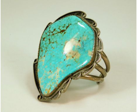 SILVER BANGLE. A North American Indian sterling silver &amp; turquoise large bangle. Turquoise stone 7.5 x 6.5cm max.