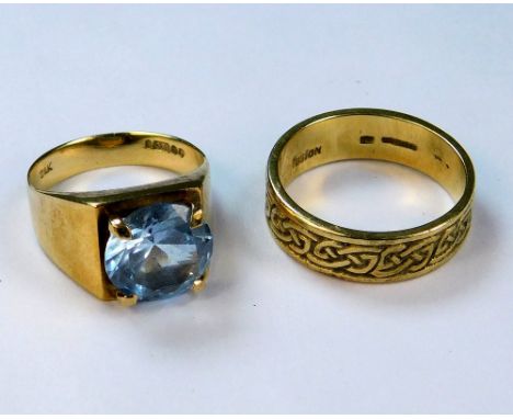 GOLD RINGS. A 9ct. gold Celtic strapwork band &amp; a 9ct. gold dress ring, set a blue stone. Approx. 8.8g.