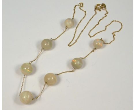 OPAL NECKLACE. An Edwardian necklet of seven graduated opal beads (Approx. 40ct.) on 9ct. gold chain. Length 48cm.