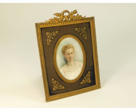 PORTRAIT MINIATURE.A portrait miniature hand painted on ivory, of a young girl wearing a lace blouse, unsigned. Ornate gilt b