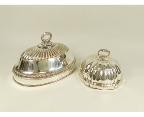 MEAT COVERS. A circular, fluted, EPNS on copper meat cover with engraved coat of arms, diameter 23cm. Also a large Victorian 