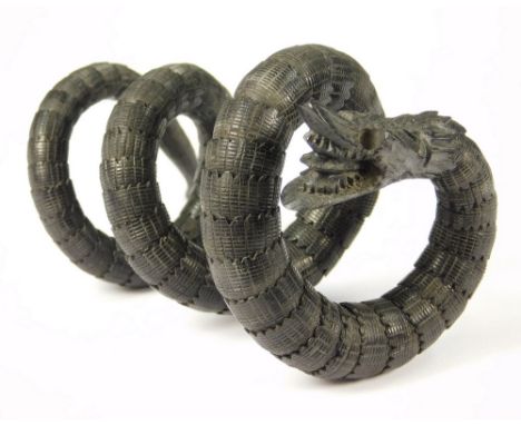 CHINESE BANGLE. A Chinese articulated wood bangle, the body &amp; head carved as a sea serpent. (eyes missing).