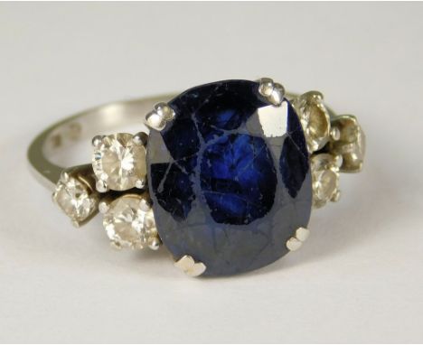 SAPPHIRE RING. An 18ct. gold, Swiss made, sapphire &amp; diamond cluster ring, the sapphire 11mm x 11mm. (K/L).