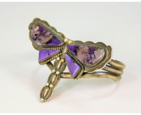 DRAGONFLY BANGLE.An oxidised silver coloured metal dragonfly bangle, the wing set with purple hardstones. Width 7.5cm.