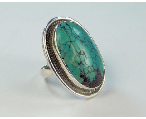 DRESS RING. A large silver &amp; turquoise set dress ring. (N). Size of face 3.5 x 2.5cm.