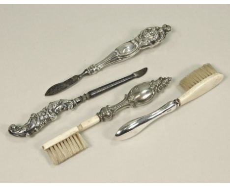 BRUSHES ETC.A silver mounted bone moustache brush, one other moustache brush with silver plated handle & two other silver mou