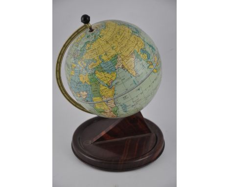 A 1950s Chad Valley tinplate terrestrial globe on simulated rosewood base.