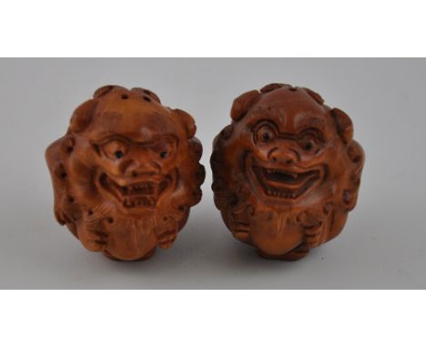 Two Chinese hardwood netsuke carved as Dogs of Fo