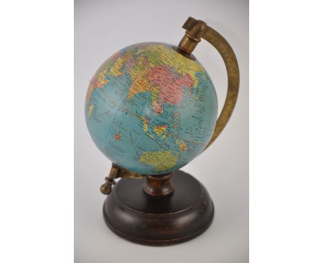 A small mid 20th century desk globe, set out with political cartography, H. 22cm.