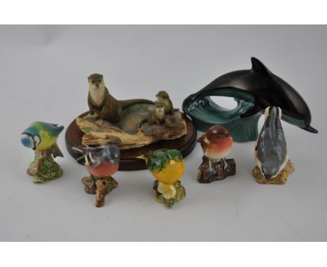 A Beswick model of a green finch, together with four further similar of English domestic birds; together with a Poole dolphin