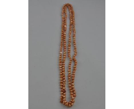 A string of light brown baroque pearls, of a broadly uniform size, L. 160cm.