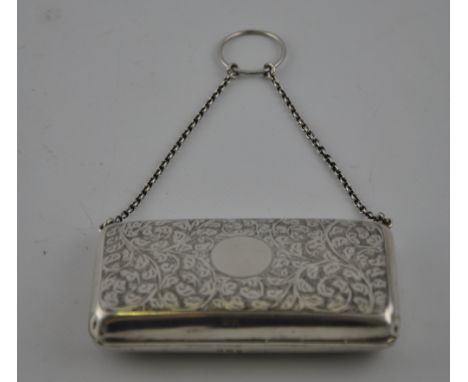 A George V ladies rectangular silver purse chain hung with ring handle, the foliate engraved body with tan leather interior, 