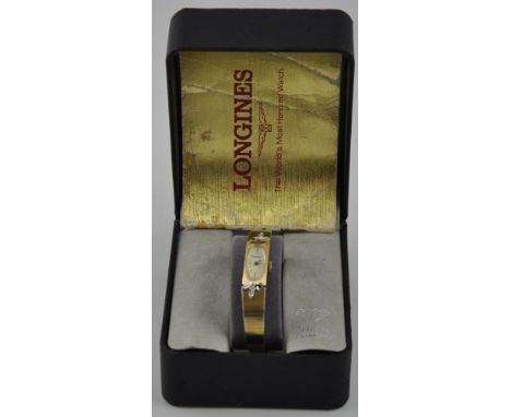 A ladies Longines wristwatch, the mother-of-pearl oval dial set out in baton numerals, on an integral plated strap set with d