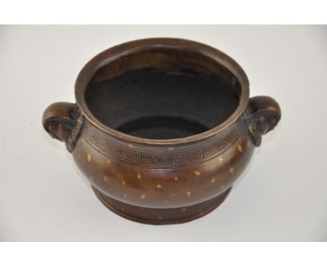 A Chinese bronze bowl, with bird mask lug handles and six character mark to base, W. 16cm.